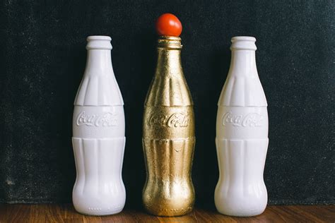 Three White and Brass Coca-cola Bottles · Free Stock Photo