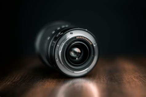 Selective Focus Photography of Camera Lens on Wooden Surface · Free Stock Photo