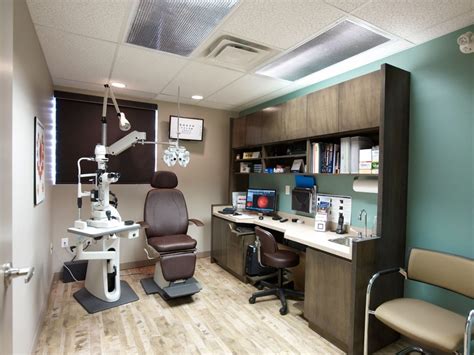 a dentist chair sitting in front of a desk with a monitor on top of it