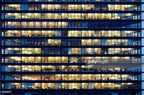 Lots of people working late. Employees seen as silhouettes against... | Night window, Retail ...