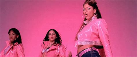 three women in pink jackets and jeans are standing on a stage with one ...