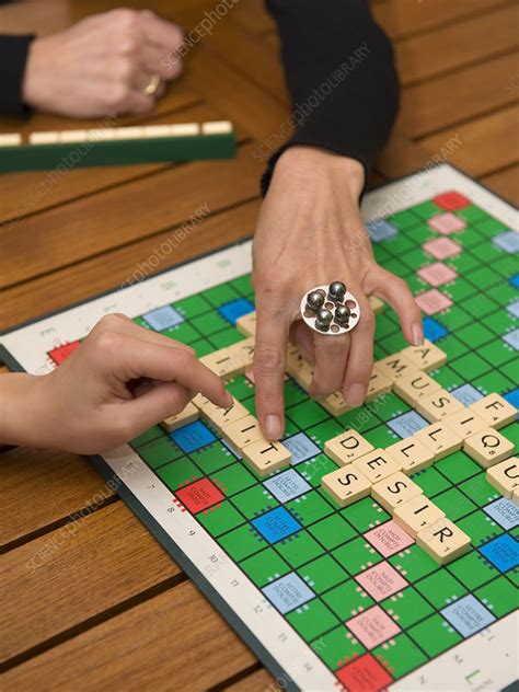 Family playing scrabble - Stock Image - C010/7416 - Science Photo Library