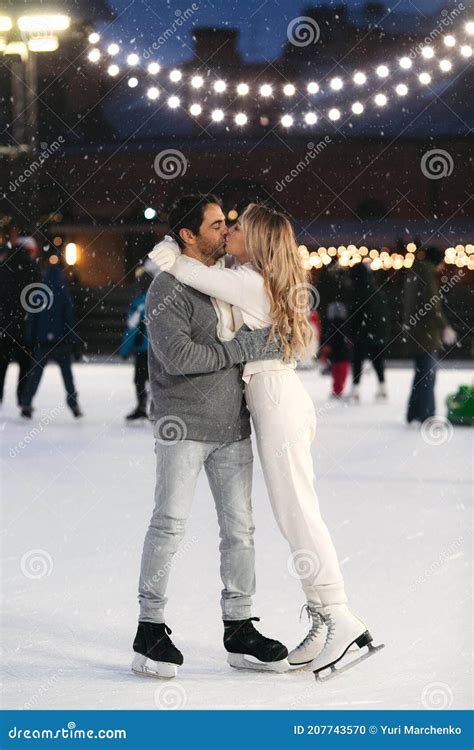 Happy Couple of Lovers Having Fun Hugging an Kissing at Ice Skating ...