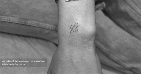 Tattoo of the number 28 located on the wrist.