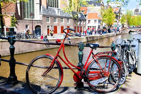 Vintage Red Bicycle Near a Canal in Amsterdam Stock Image - Image of canal, kings: 53479003