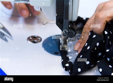 Hands work a sewing machine Stock Photo - Alamy