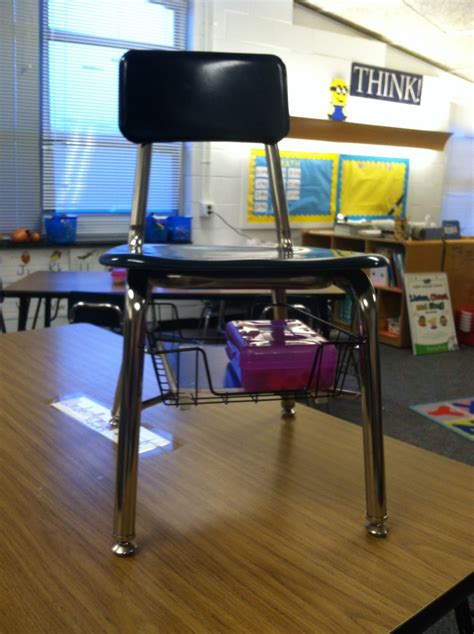 a chair sitting on top of a wooden table