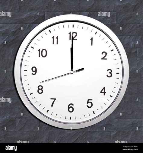 wall clock set at noon or twelve o'clock Stock Photo - Alamy