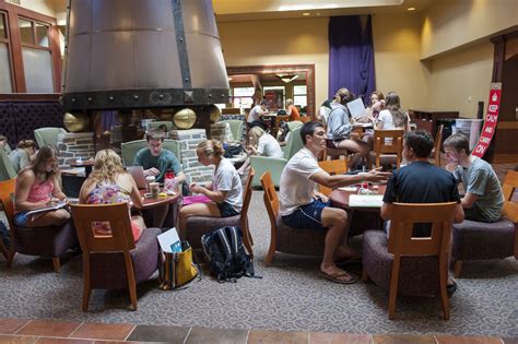 many people are sitting at tables in a restaurant