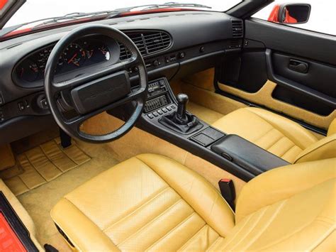 the interior of a sports car with yellow leather seats