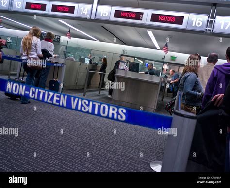 USA Immigration passport control with biometric digital checks, entry point queue for non US ...