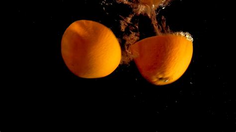Sliced Oranges Dropping on Water · Free Stock Video