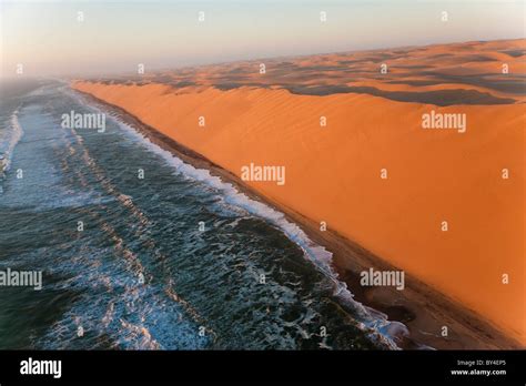 Aerial view over sand dunes & sea, Namib Desert, Namibia Stock Photo ...