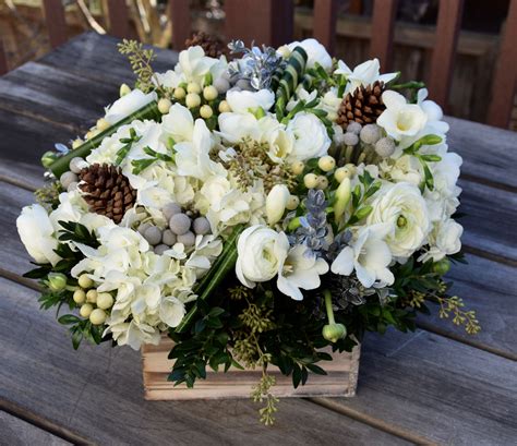 Winter flower arrangement in a rustic container with lots of floral goodies in whi… | Flower ...