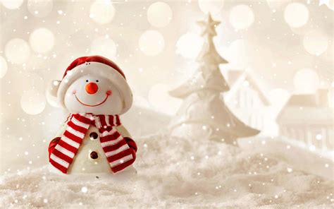 Download A cheery Christmas snowman smiles against a frosty winter background Wallpaper ...