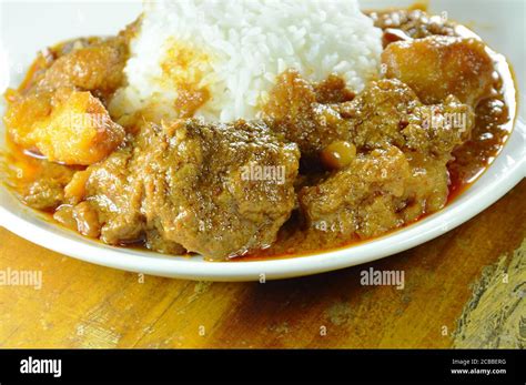 pork curry and potato with rice on plate Stock Photo - Alamy