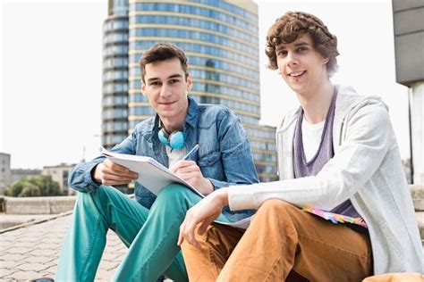 Portrait of Young Male College Students Studying on Steps Against ...