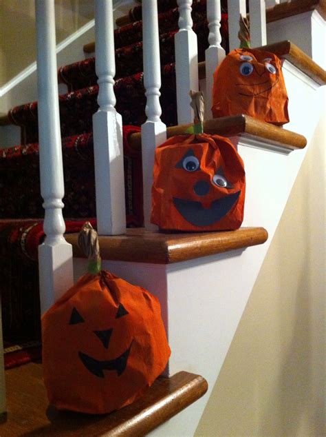 three pumpkin bags sitting on top of a set of stairs