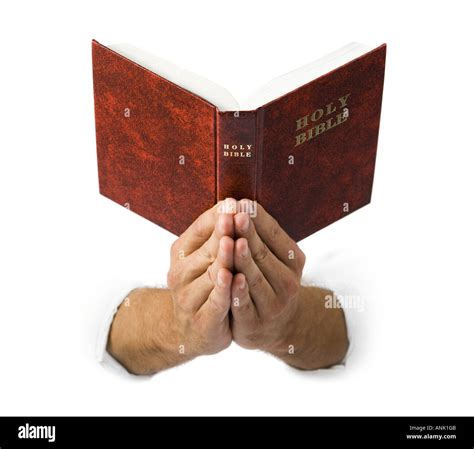 Close up of praying hands holding the Bible Stock Photo - Alamy