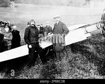 Pilot Louis Bleriot stands in the cockpit of his plane while mechanics give the plane a final ...