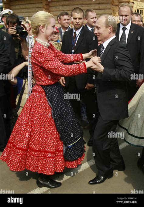 Russian President Vladimir Putin dances at a festival celebrating Finno ...