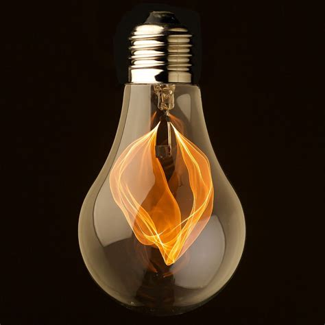 Vintage clear glass flicker flame bulb. This lamp is a functional, vintage filament bulb that ...