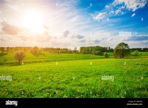 green hill and beautiful sunset Stock Photo - Alamy