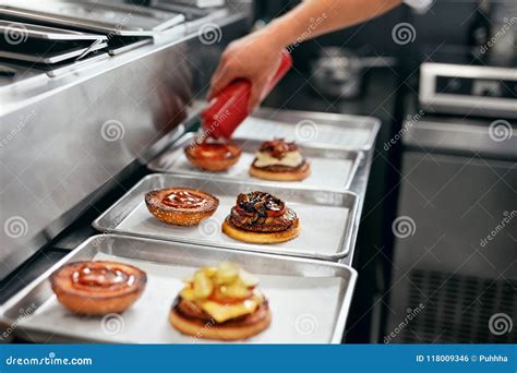 Burger Restaurant. Closeup Chef Cooking Burgers in Kitchen Stock Photo ...