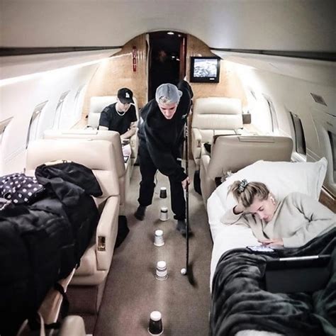 Justin Bieber playing hockey on a private jet.