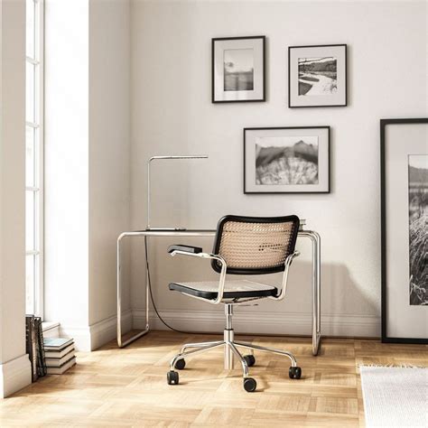 an office chair sitting in front of a wall with pictures on the walls ...