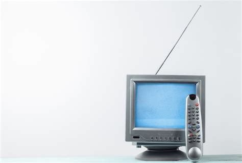 Premium Photo | Mini retro tv antenna receiver on a white. old fashioned tv set with remote.