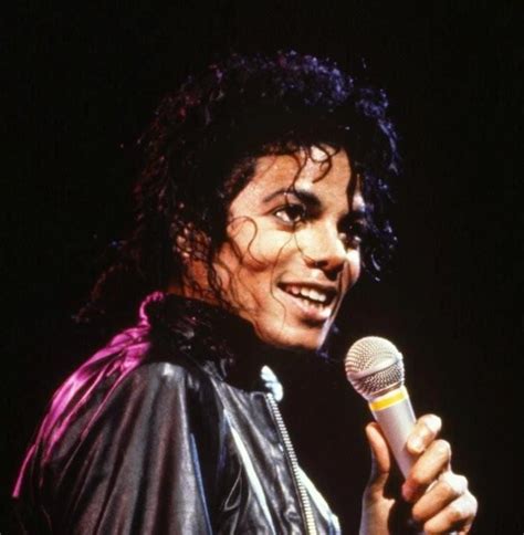 michael jackson singing into a microphone on stage