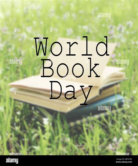 Stacked books in grass. World Book Day poster Stock Photo - Alamy