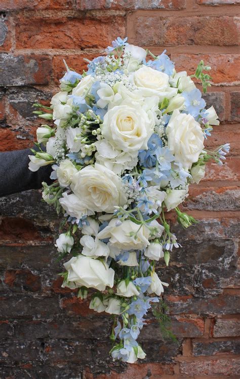 cascading bridal bouquet in pale blue and ivory flowers - avalanche roses - blue delphinium ...