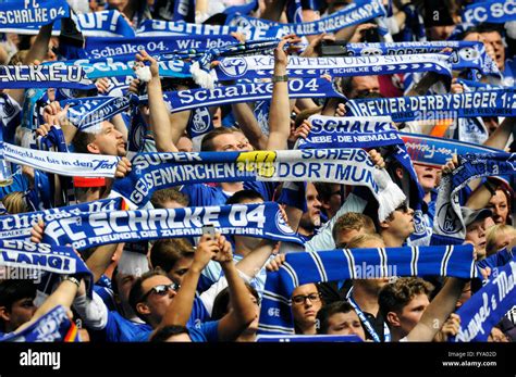 Schalke fans on the north stand holding up scarves, FC Schalke 04 - Borussia Dortmund, Veltins ...