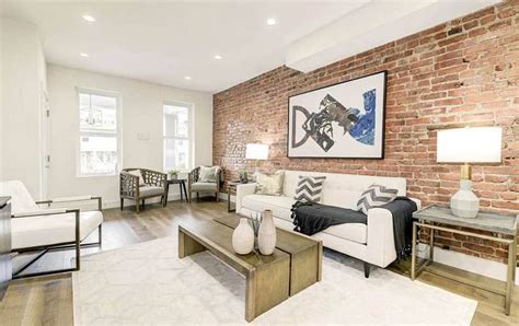 Exposed brick wall living room design with wood flooring and hanging picture Exposed Brick Wall ...