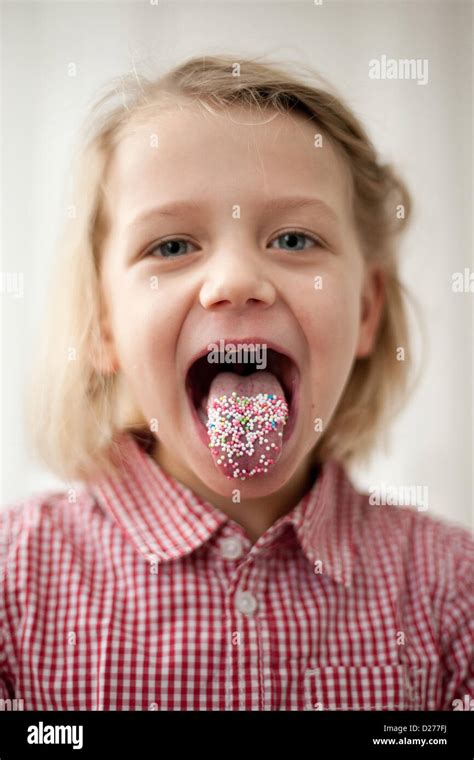 A little girl has her tongue full of Hundreds and Thousands Stock Photo - Alamy