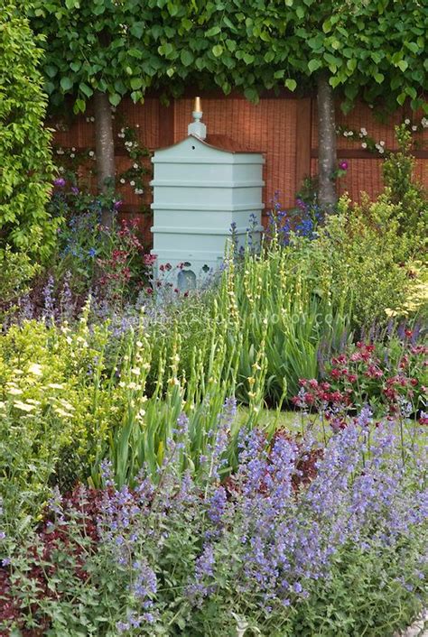 Beehive in beautiful spring garden with bee friendly attracting plants, including Nepeta | Bee ...