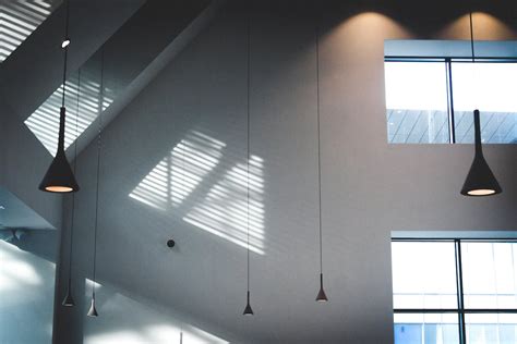 Black Pendant Lamps in White Building · Free Stock Photo
