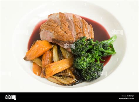 Roast duck with vegetables and jus Stock Photo - Alamy