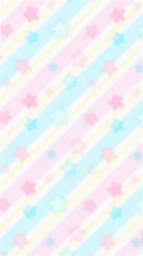 a cell phone sitting on top of a pink and blue striped wallpaper with stars