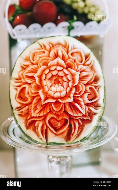 Watermelon carving art. Carved beautiful flower on a large watermelon to serve on a sweet table ...