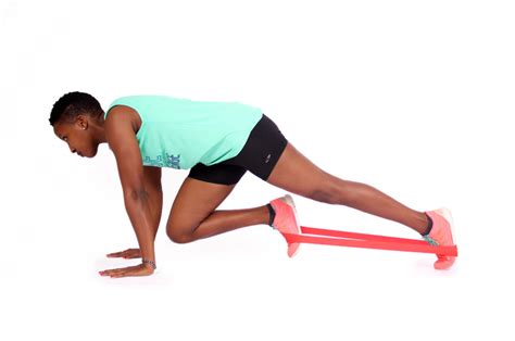 Female Doing Mountain Climbers Exercise While Wearing A Resistance Band