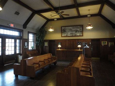 a large room with wooden furniture and windows