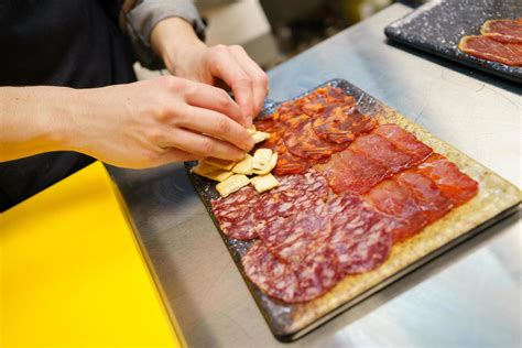 Unrecognizable chef preparing a plate of Iberian cured meats platter. 5892693 Stock Photo at ...