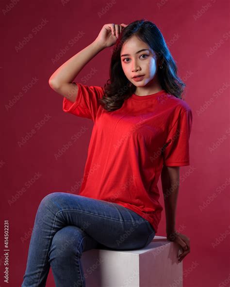 Young female model wearing blank T-shirt in studio background. Woman in ...