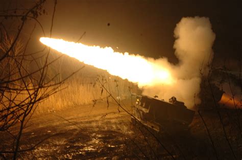 WHOOSH.. BOOM. A US Army M270 Multiple Rocket Launcher System lights up the night during a ...