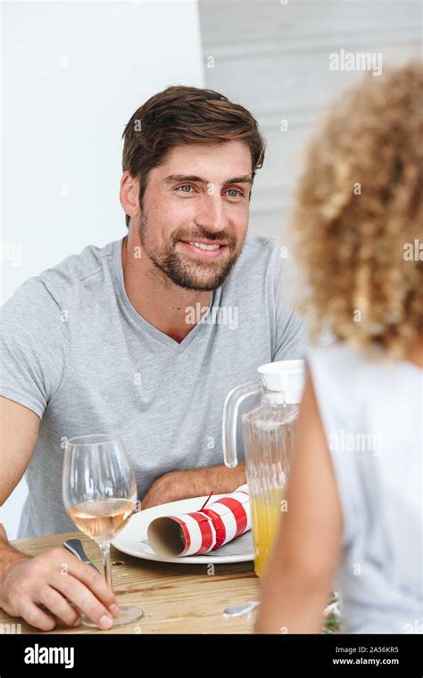Father listening attentively to daughter at dining table Stock Photo - Alamy