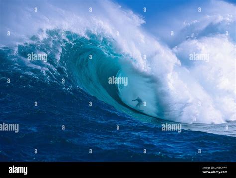 Professional surfer, Garrett McNamara, surfing in the barrel at Jaws ...