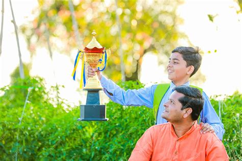 Premium Photo | Cute indian farmer child in school uniform with his father at agriculture field